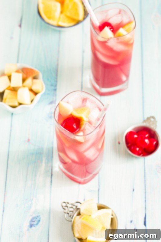 Black Cherry Sangria in a glass, with a view of a festive setting