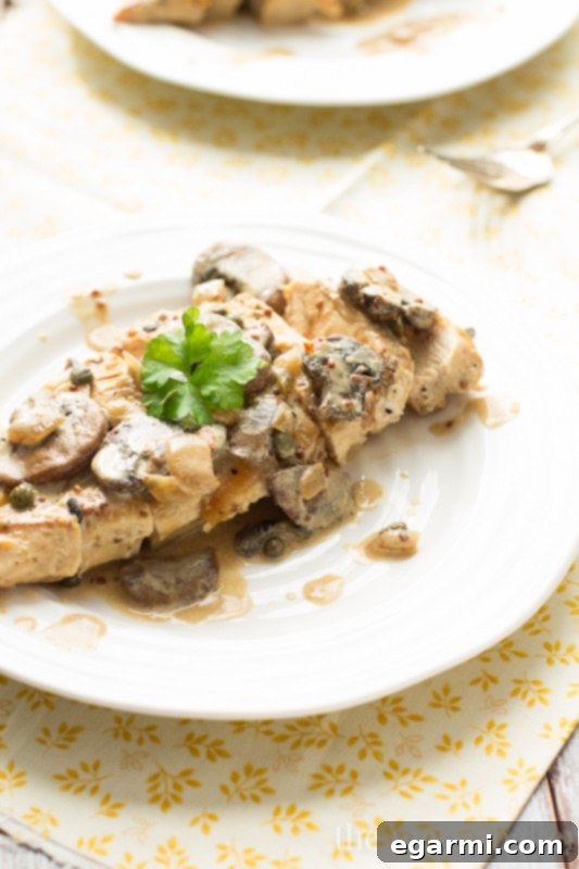 Pan-seared chicken breasts in a creamy Dijon mushroom sauce, ready in 30 minutes