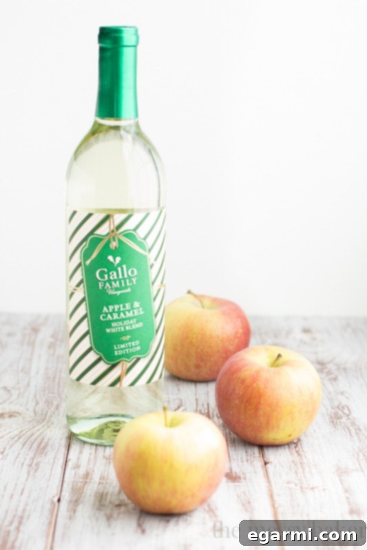 Close-up of Sparkling Caramel Apple Sangria in a glass, garnished with apple