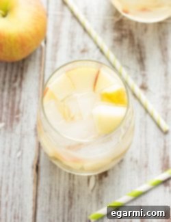 A pitcher of Sparkling Caramel Apple Sangria with fresh apples