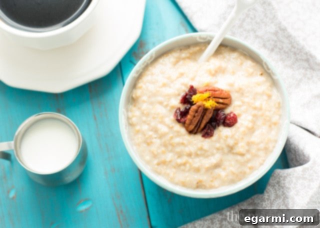 Eggnog Steel Cut Oatmeal garnished with cranberries and pecans in a festive setting