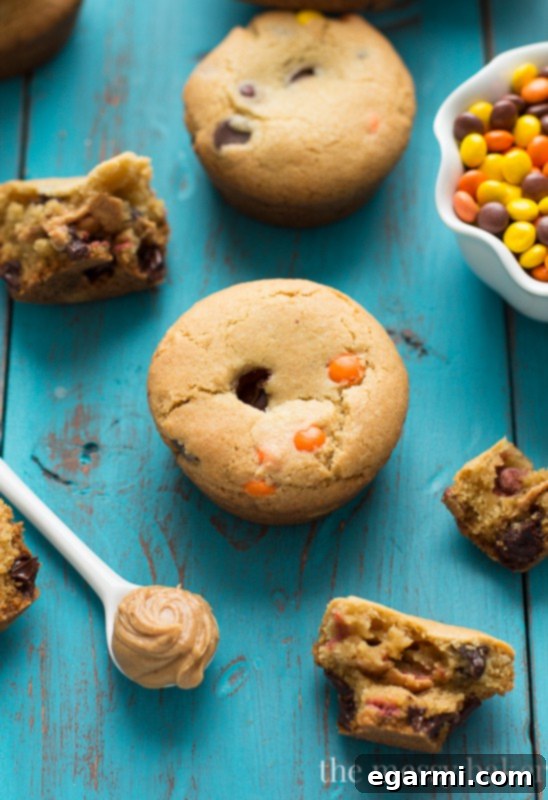 Close-up of freshly baked Peanut Butter Stuffed Chocolate Chip Cookie Cups, golden brown and inviting