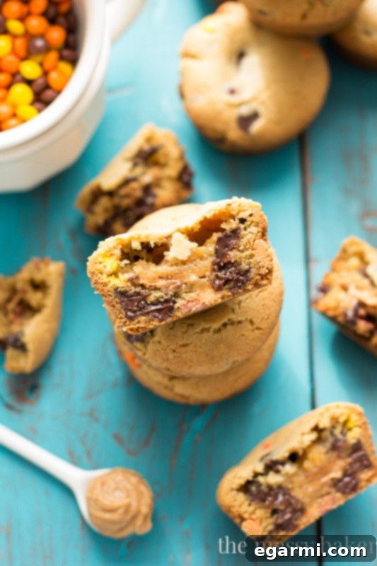 A stack of golden brown Peanut Butter Stuffed Chocolate Chip Cookie Cups on a cooling rack