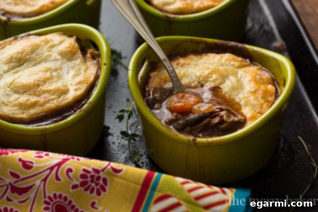 Assembling individual steak and mushroom pies with puff pastry.