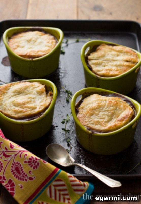 Golden-brown puff pastry on a baked steak and mushroom pie, ready to serve.
