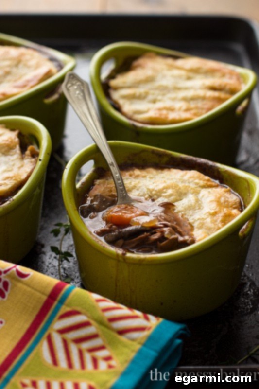 Close-up of a delectable steak and mushroom pie with tender beef and flaky crust.