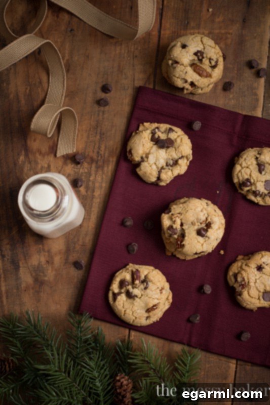 Close-up of a brown butter pecan chocolate chip cookie, highlighting its soft, chewy interior studded with melted chocolate and crunchy pecans.