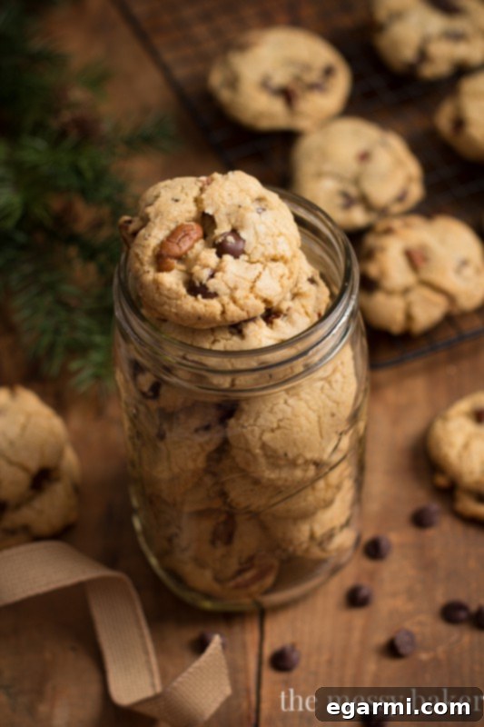 A plate of warm, freshly baked brown butter pecan chocolate chip cookies, perfect for sharing or enjoying with a glass of milk.
