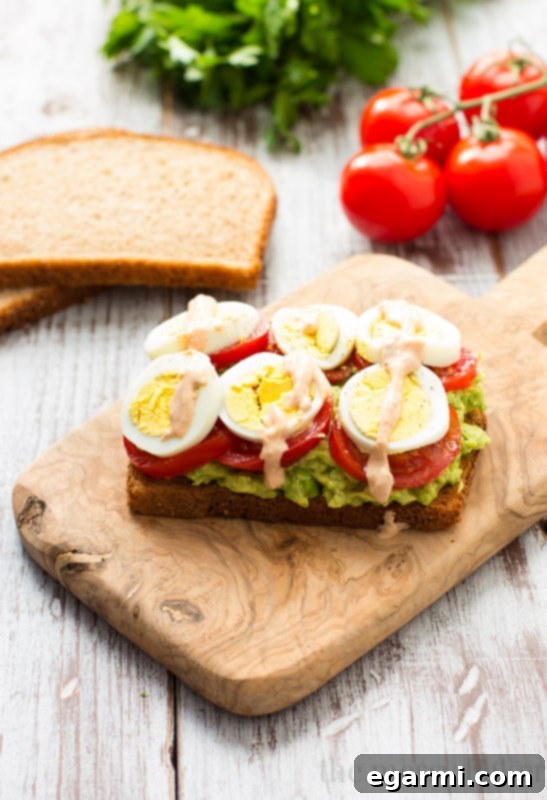 Healthy Avocado, Tomato, and Sliced Egg Toast. This open-faced sandwich is perfect for breakfast or lunch.
