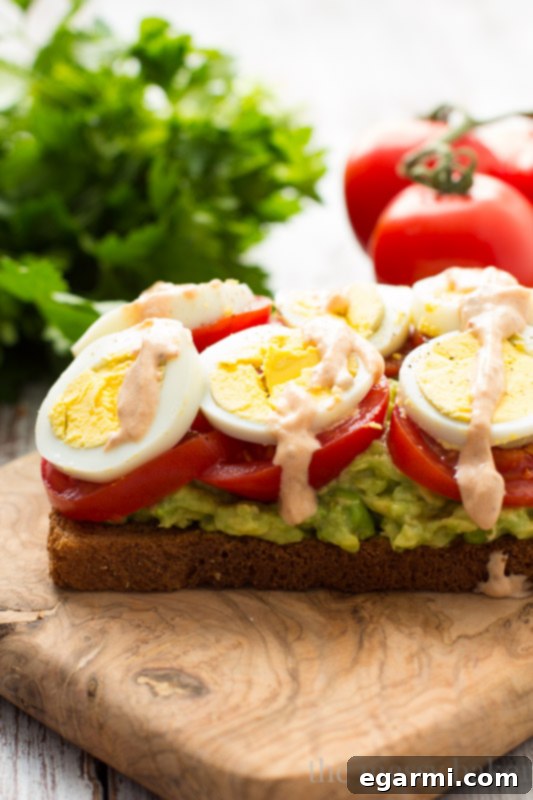 Healthy Avocado, Tomato, and Sliced Egg Toast. This open-faced sandwich is perfect for breakfast or lunch.
