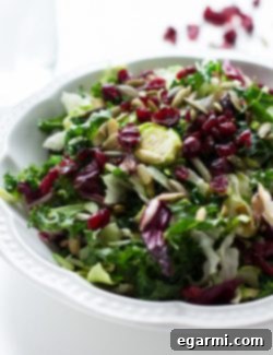 A close-up of the finished Warm Sweet Kale Salad with Poppyseed Dressing, ready to be served.