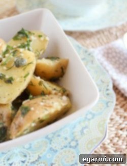 Final plated serving of Buttery Herbed Potatoes with fresh dill and lemon wedges.