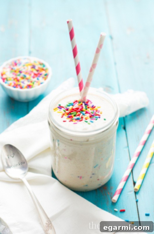 Vibrant and creamy Healthy Funfetti Shake in a tall glass, garnished with colorful sprinkles.