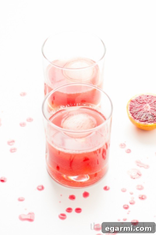 A collection of Blood Orange Bourbon Fizz Cocktails on a tray
