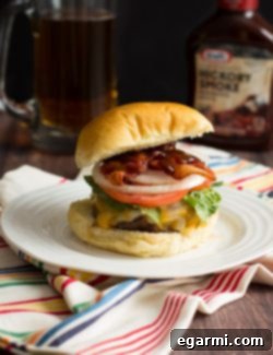 A freshly grilled Jalapeño Popper Stuffed Bacon Burger on a plate.