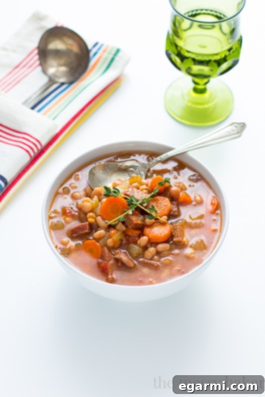 Close-up of Slow Cooker Navy Bean Soup with Ham simmering in the pot