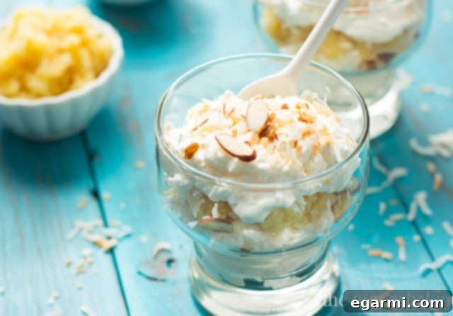 Ingredients for Pina Colada Fool laid out on a table, including pineapple, heavy cream, coconut extract, and toasted nuts.