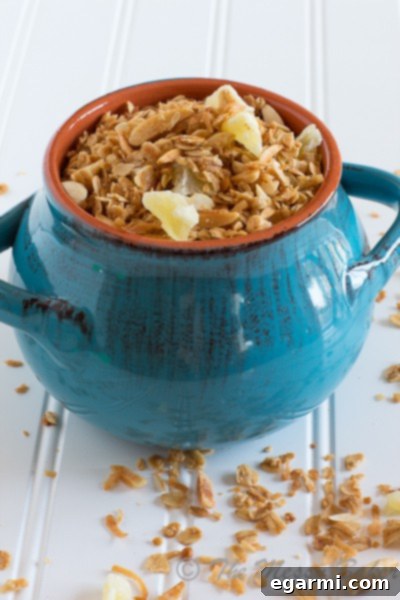Pina Colada Granola served in a bowl with fresh fruit.