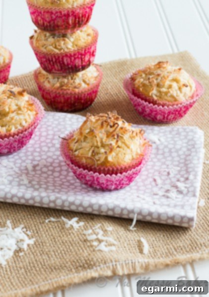 Healthy Pina Colada Muffins topped with coconut flakes.