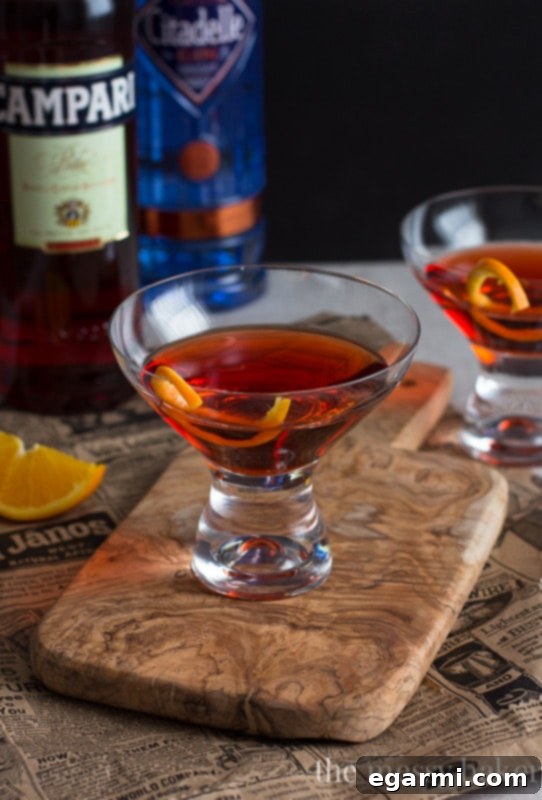 Classic Negroni Cocktail | A close-up shot of a Negroni with an orange slice, highlighting its vibrant color.