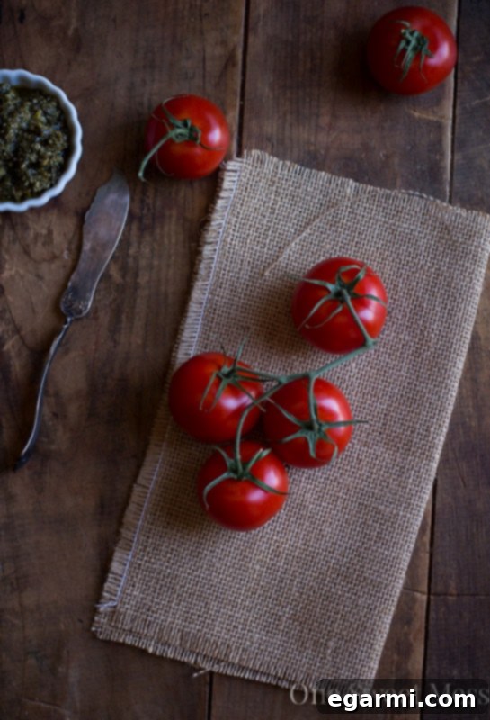 Close-up of roasted tomatoes on a baking sheet, ready for the sandwich