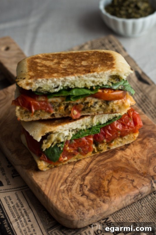 Finished Roasted Tomato Caprese Grilled Cheese Sandwich, sliced and ready to serve