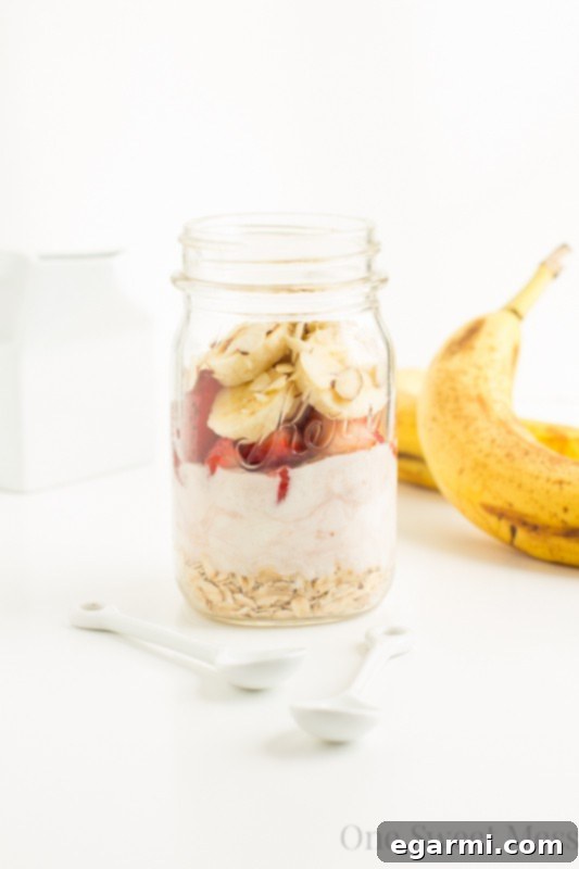 Close-up of a jar of Strawberry Banana Overnight Oats, showcasing layers of creamy oats, sliced strawberries, and bananas, ready for a healthy and quick breakfast.