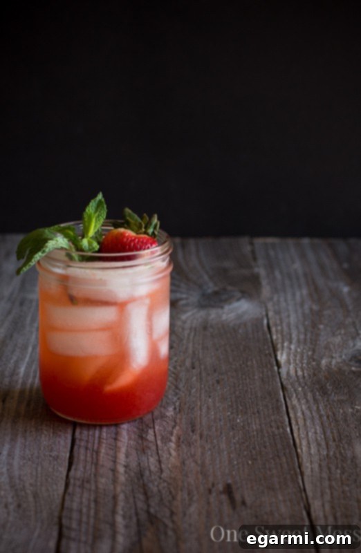 Strawberry Jam Bourbon Smash - Cocktail being poured