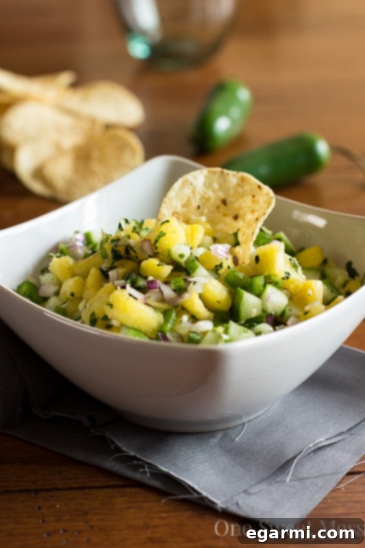 Fresh Pineapple Cucumber Salsa in a bowl with tortilla chips, ready to be served