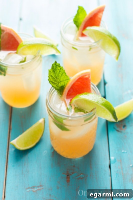 Grapefruit Honey Mojito served in a tall glass, garnished with grapefruit and mint