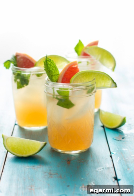 Ingredients for Grapefruit Honey Mojito laid out, including grapefruit, mint, and rum