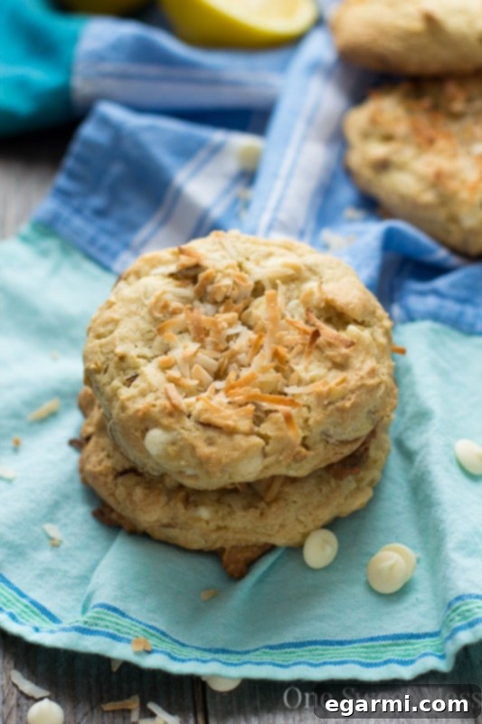 Soft-Baked Lemon Coconut Cookies stacked on a white plate, ready to be served.