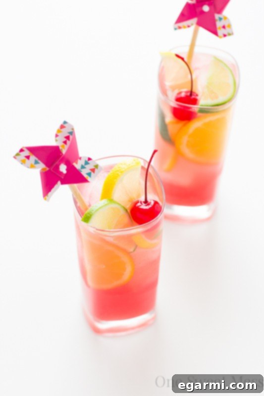 Delicious Tiki Punch served in a large pitcher, adorned with fresh fruit, and ready for an exciting party