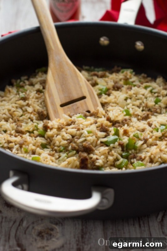Close-up of Dirty Rice simmering in a large skillet