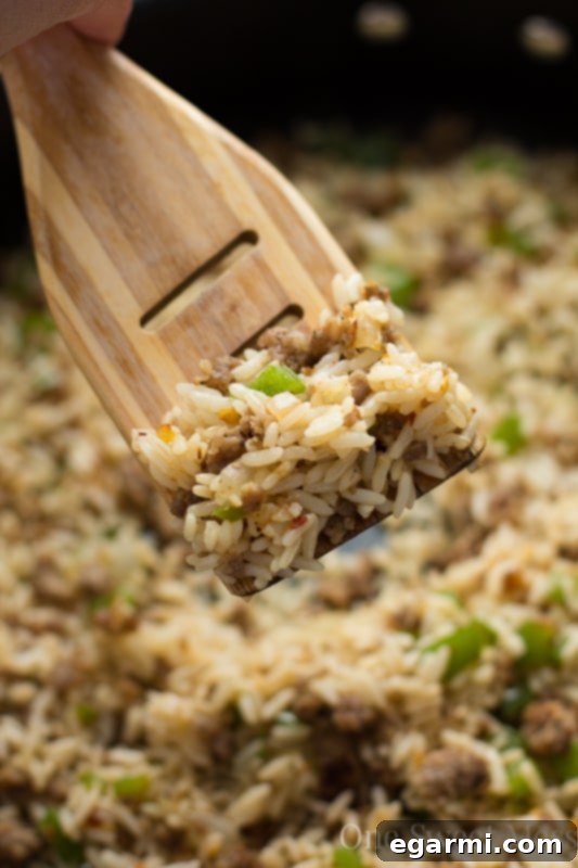 Fresh ingredients like bell pepper, onion, and spices laid out for Dirty Rice preparation