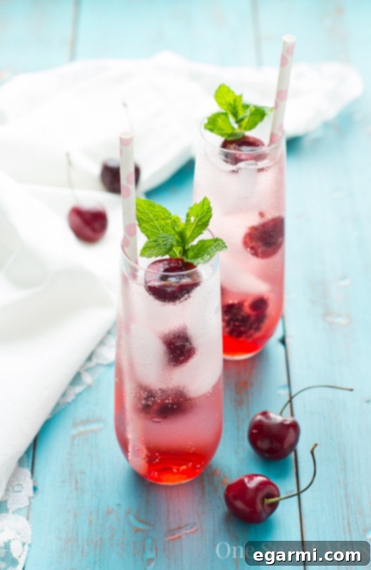 Sweet Cherry Prosecco Sparkler 6 Finished Cherry-Kissed Prosecco Spritzer with cherries and mint garnish
