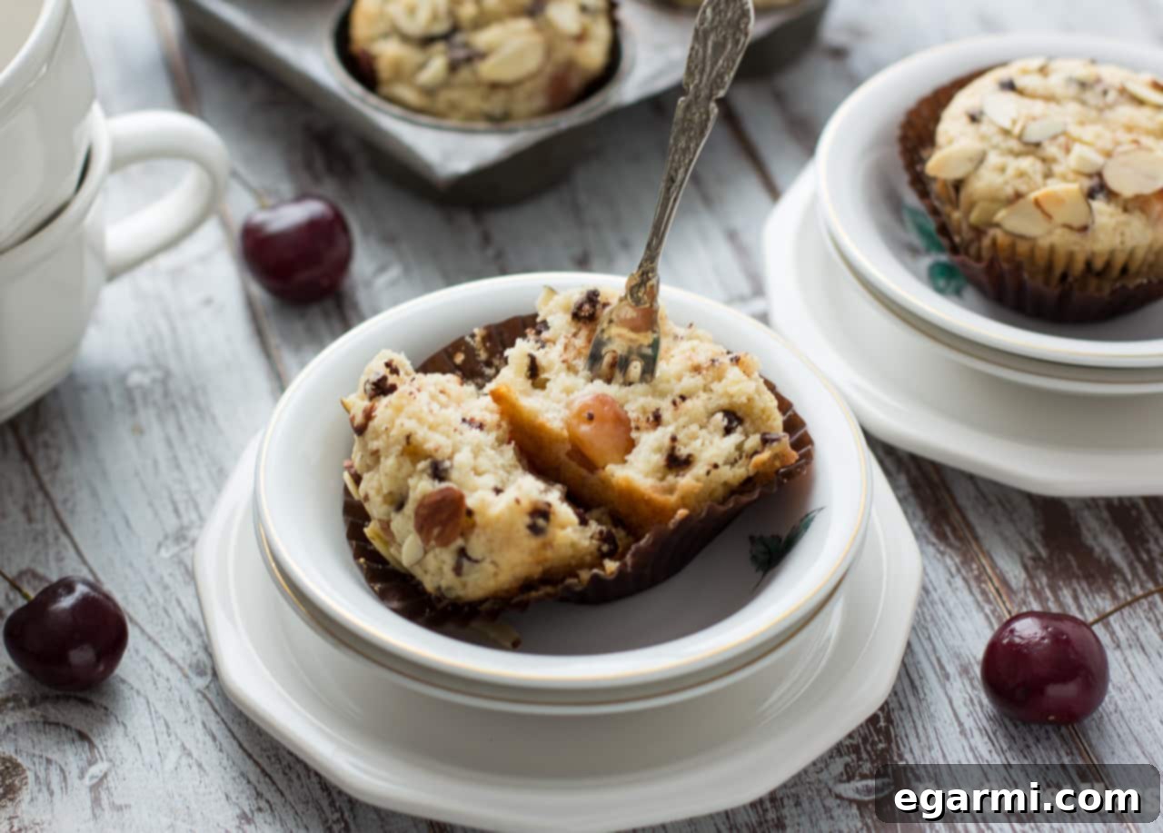 Decadent Cherry Chocolate Chip Muffins 4 Multiple freshly baked Cherry Chocolate Chip Muffins cooling on a wire rack.