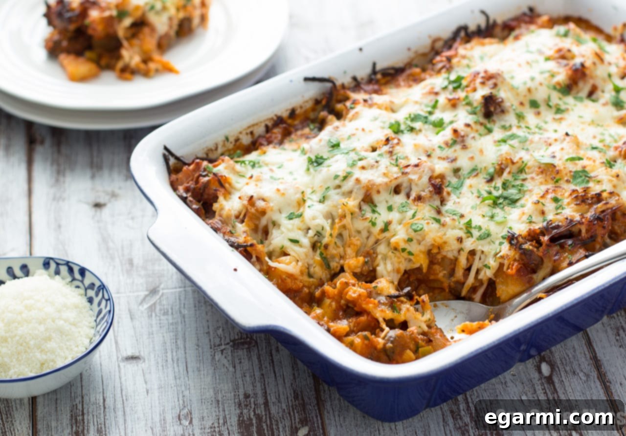 Large baking dish filled with Sausage Pizza Au Gratin Potato Casserole, fresh from the oven