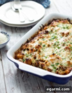 Sausage Pizza Au Gratin Potato Casserole in a baking dish, garnished with fresh parsley