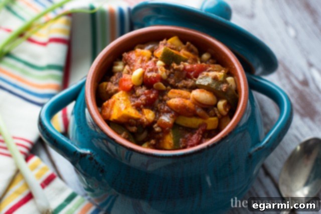 A comforting bowl of Harvest Chili brimming with seasonal vegetables and ground beef, perfect for a satisfying dinner.