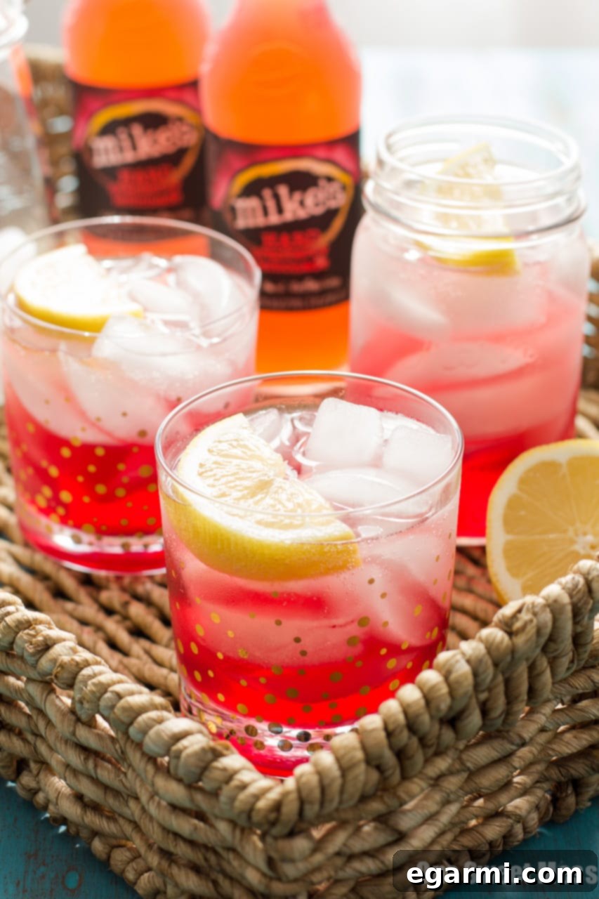 Three Cran-Apple Splash cocktails arranged for a fall celebration, highlighting their vibrant color and enticing presentation.