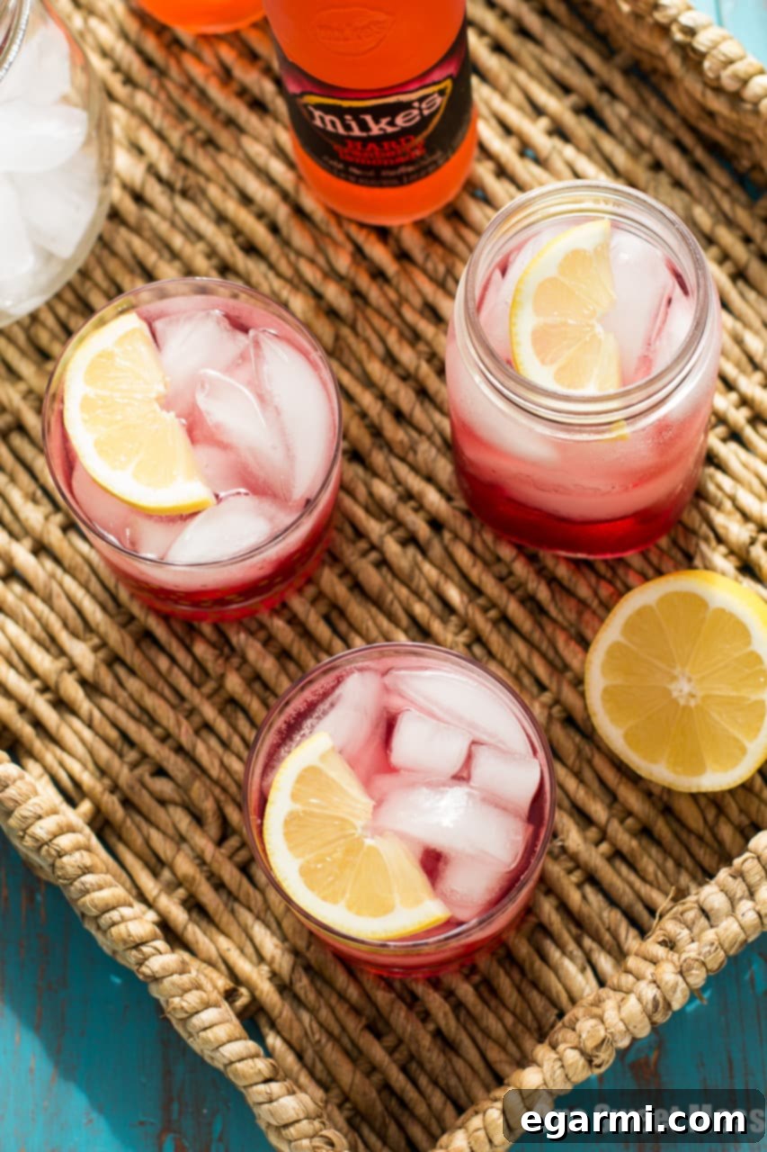 A bottle of Mike's Hard Cranberry Lemonade, a key ingredient for the Cran-Apple Splash cocktail, hinting at the crisp, tart, and sweet flavors within.
