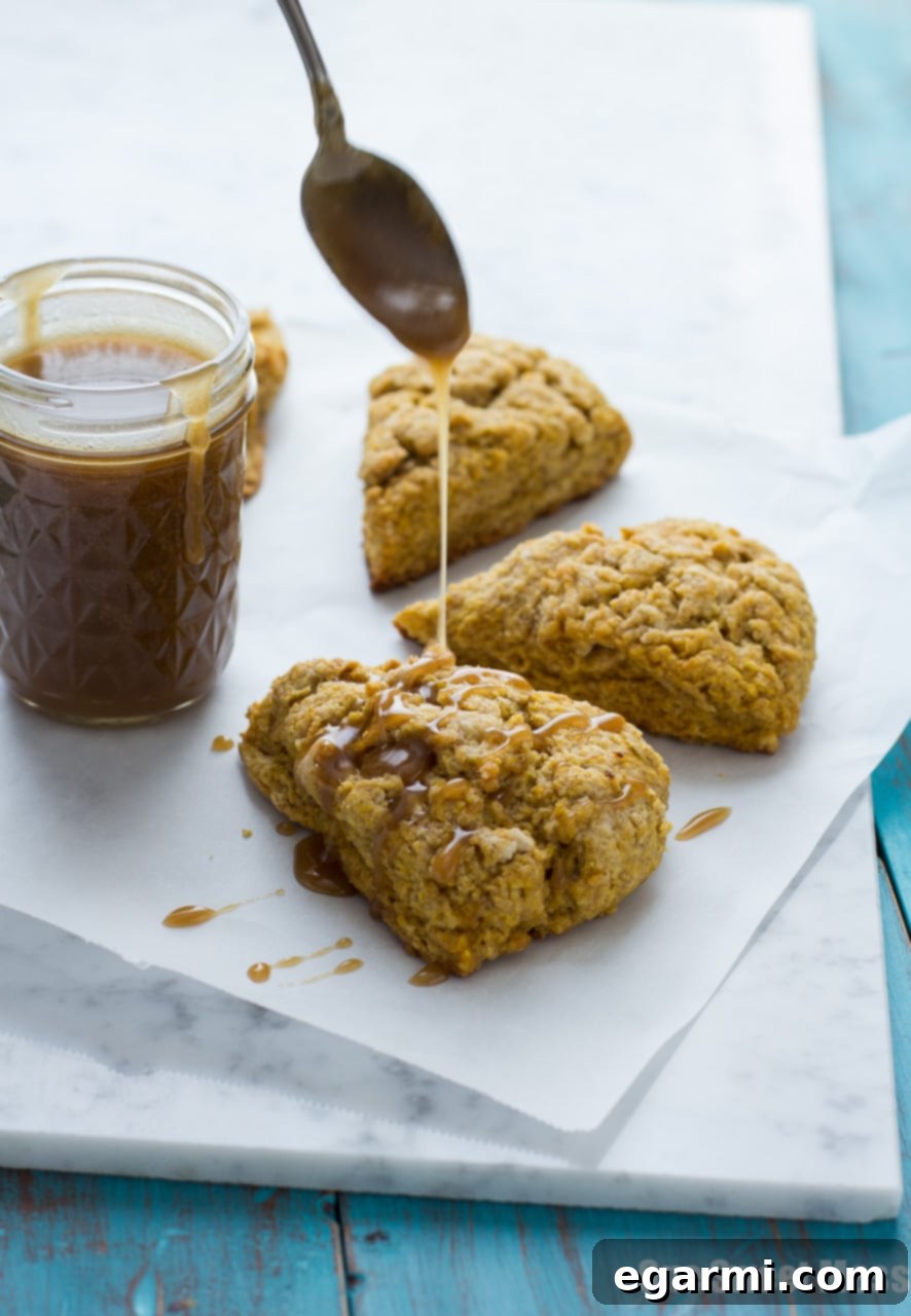 Close-up of a pumpkin spice scone with bourbon caramel glaze, showing its tender texture.