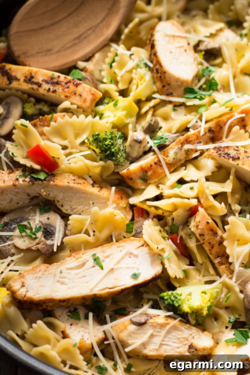 Serving of Chicken Alfredo Primavera in a bowl, showing the rich sauce, pasta, and vegetables, ideal for a quick and satisfying meal.
