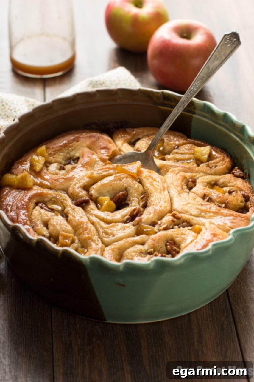 Gooey Caramel Apple Cinnamon Swirls 8 Hands rolling out sweet dough on a lightly floured surface for cinnamon rolls