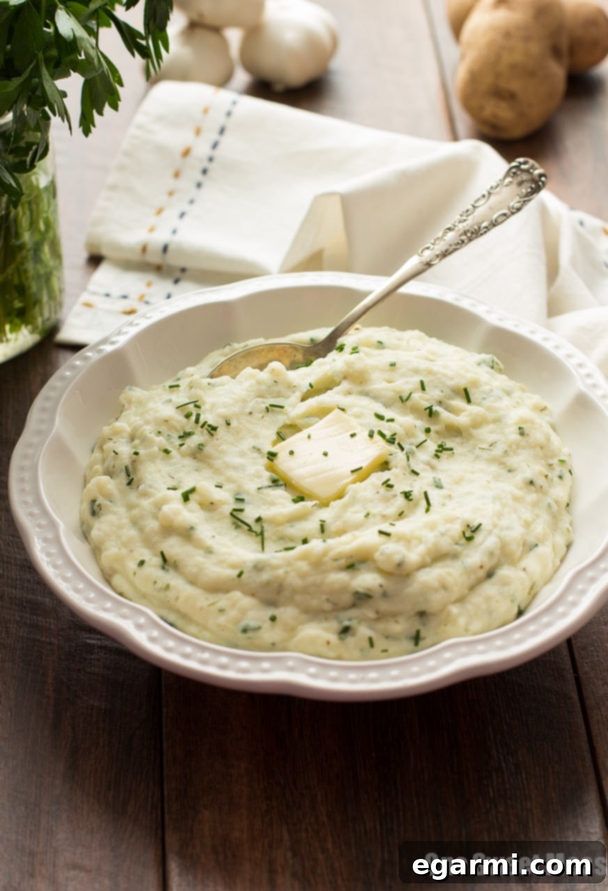 Close-up of fluffy Roasted Garlic Ranch Mashed Potatoes in a rustic serving bowl