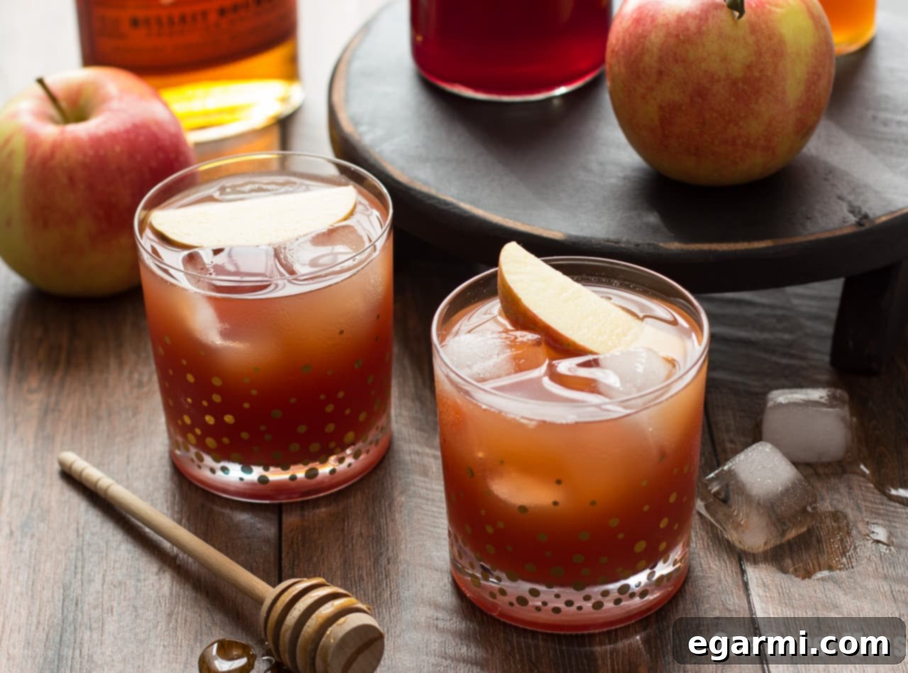 Ingredients for Pomegranate Cider Bourbon Splash, including bourbon, pomegranate juice, and apple cider