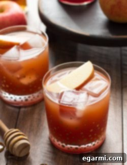 Pomegranate Cider Bourbon Splash in a rocks glass with a lemon wedge