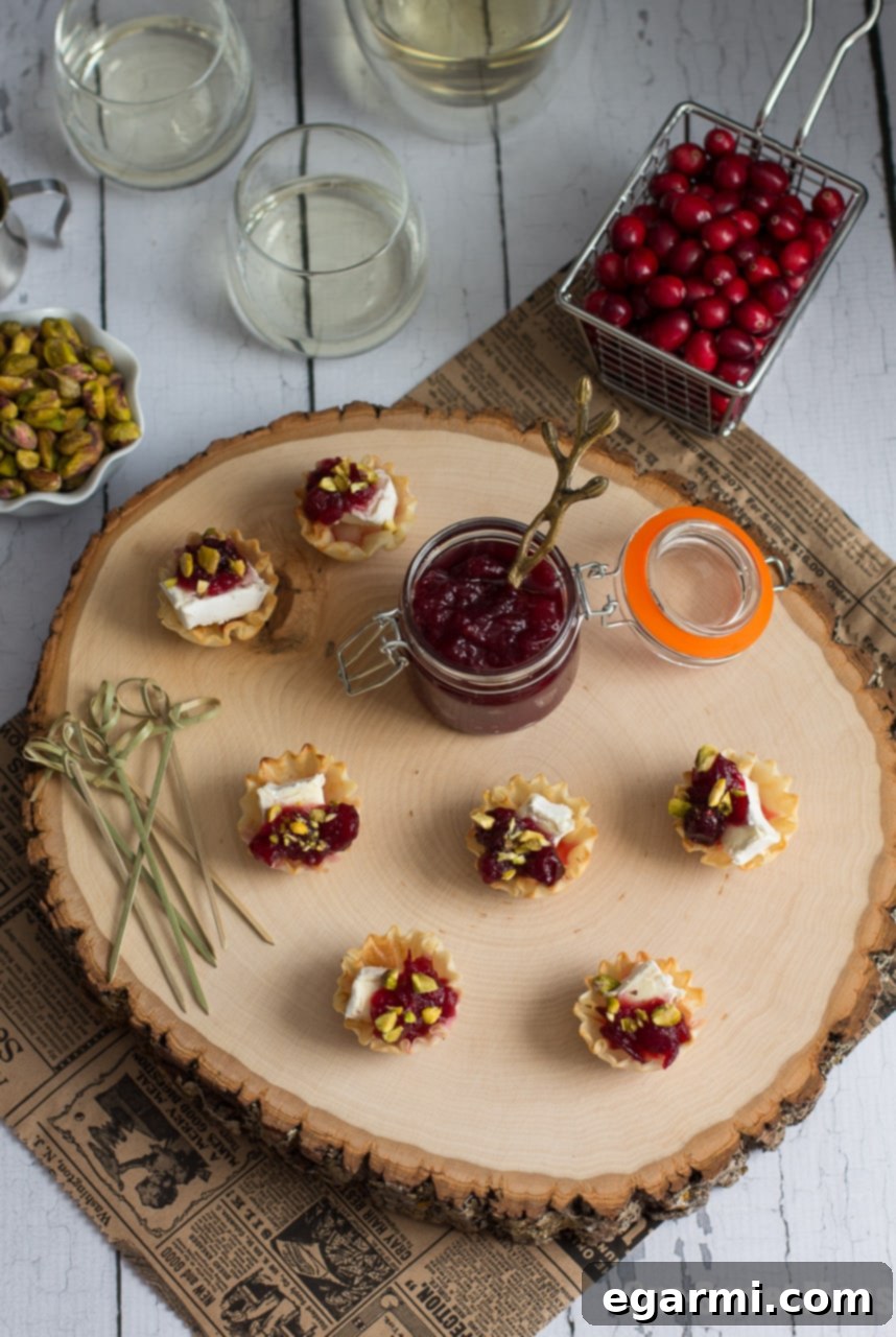 Elegant Display of Cranberry Brie Phyllo Bites on a Wooden Board